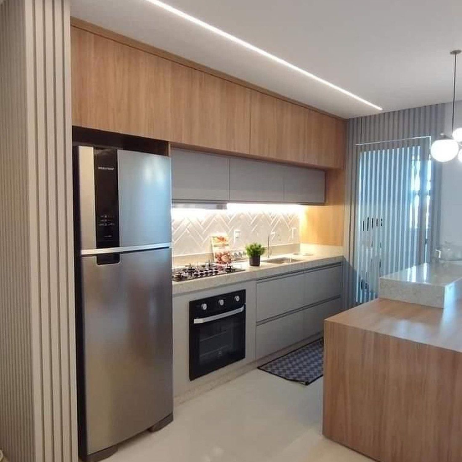 A modern kitchen with sleek wooden cabinetry and stainless steel appliances