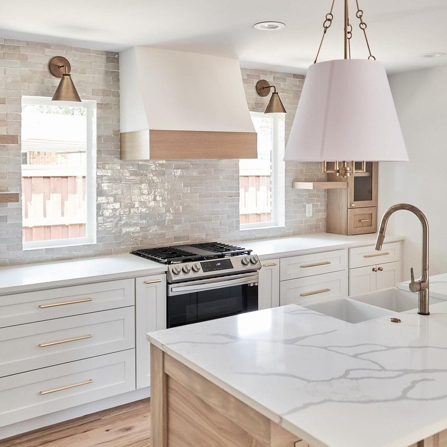 Modern and stylish kitchen with light-wood flooring and white cabinetry