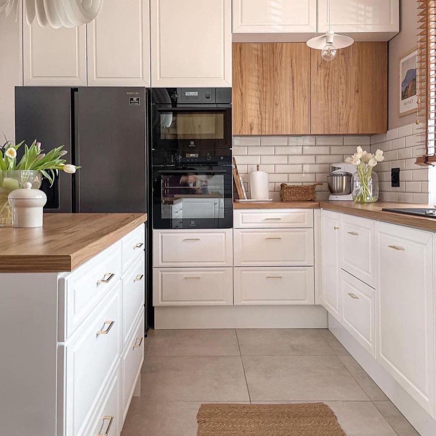 A modern kitchen with walnut wood accents and black appliances