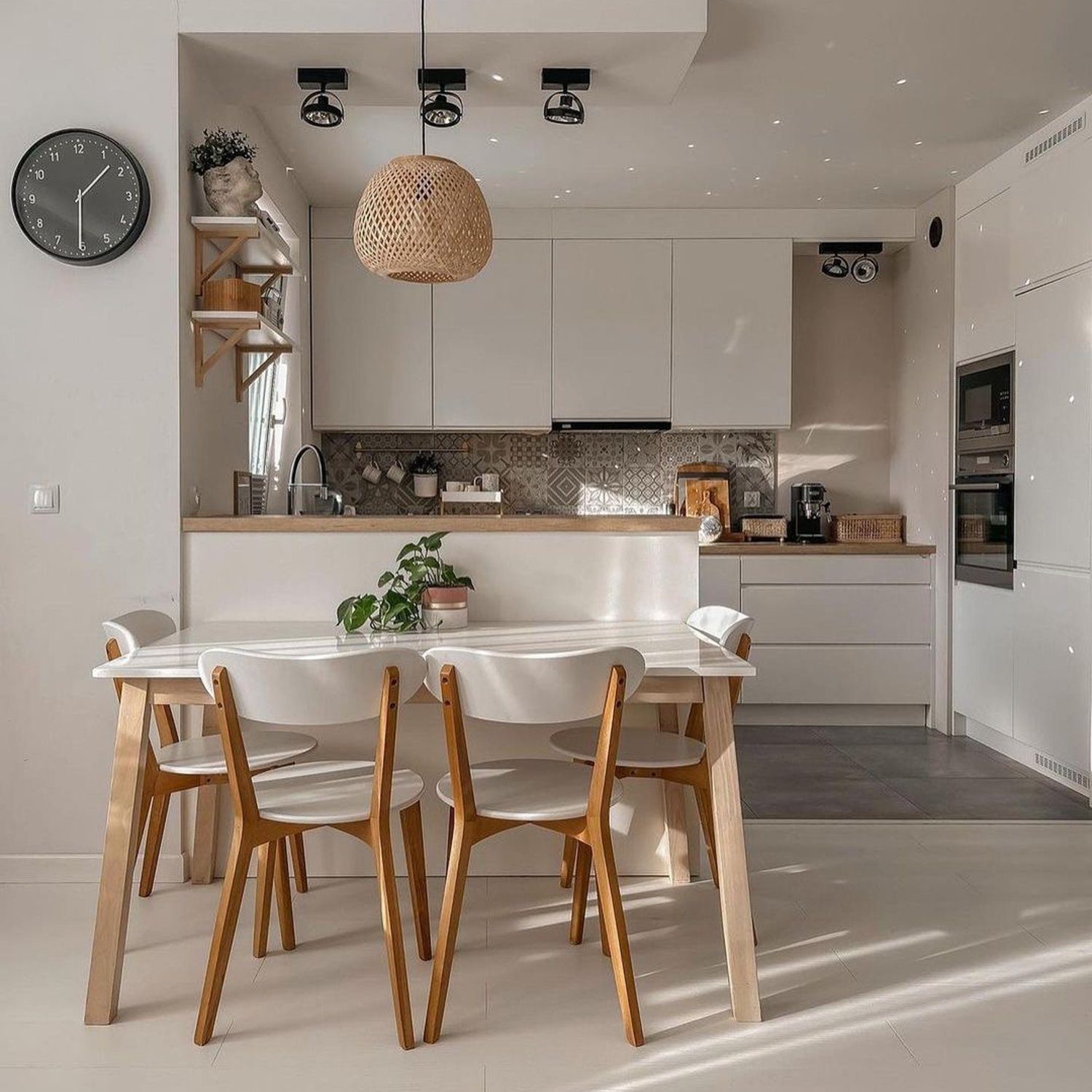 A sleek and modern kitchen design showcasing natural light, wooden accents, and contemporary finishes.