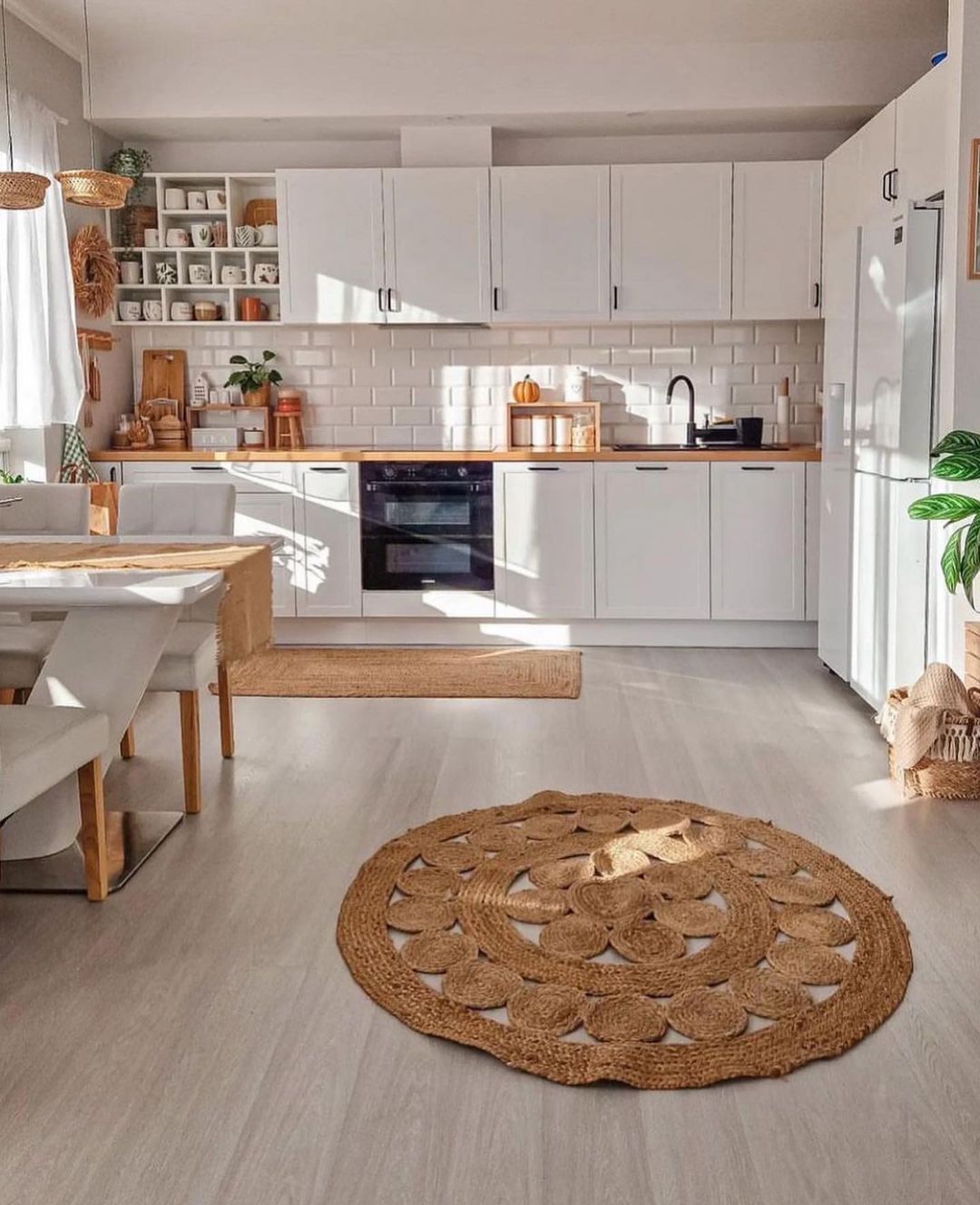 A harmoniously designed kitchen with white cabinetry and subway tiles