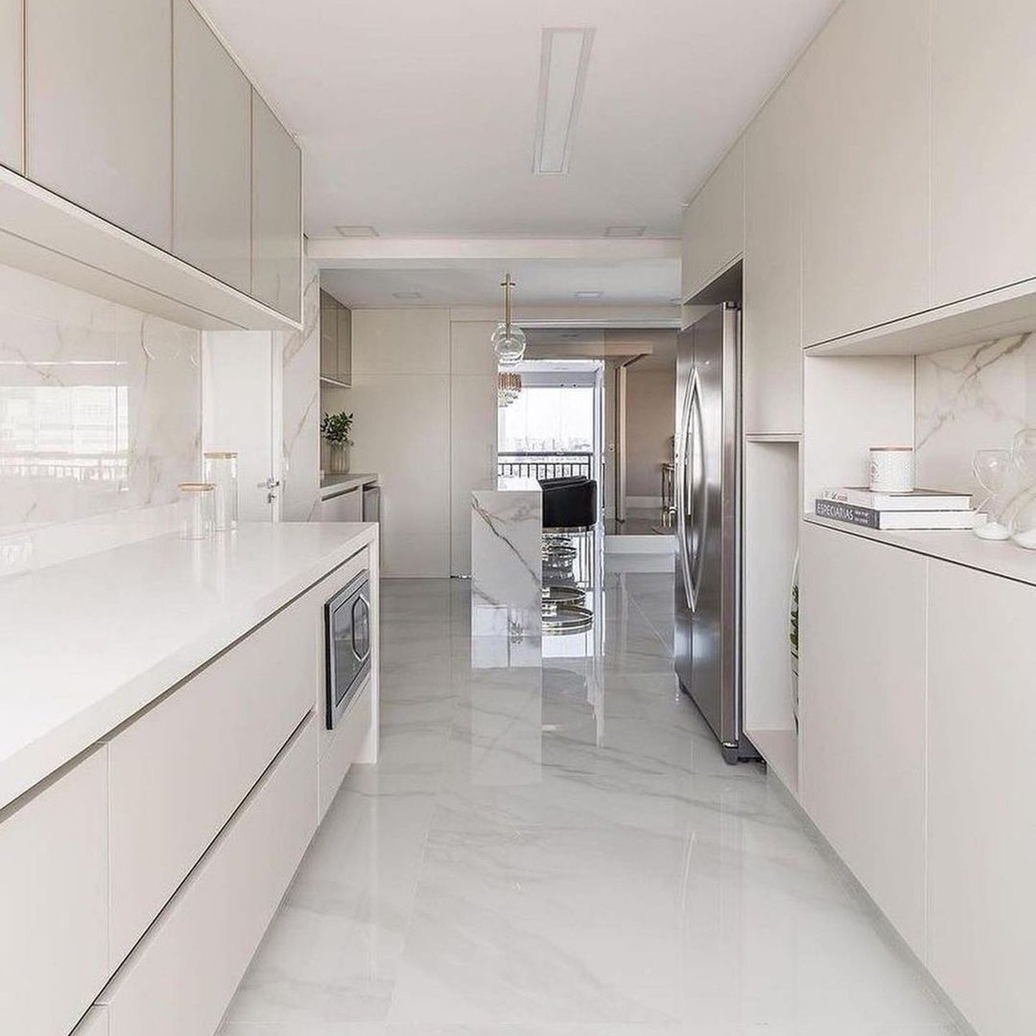 A sleek, modern kitchen interior with marble finishes