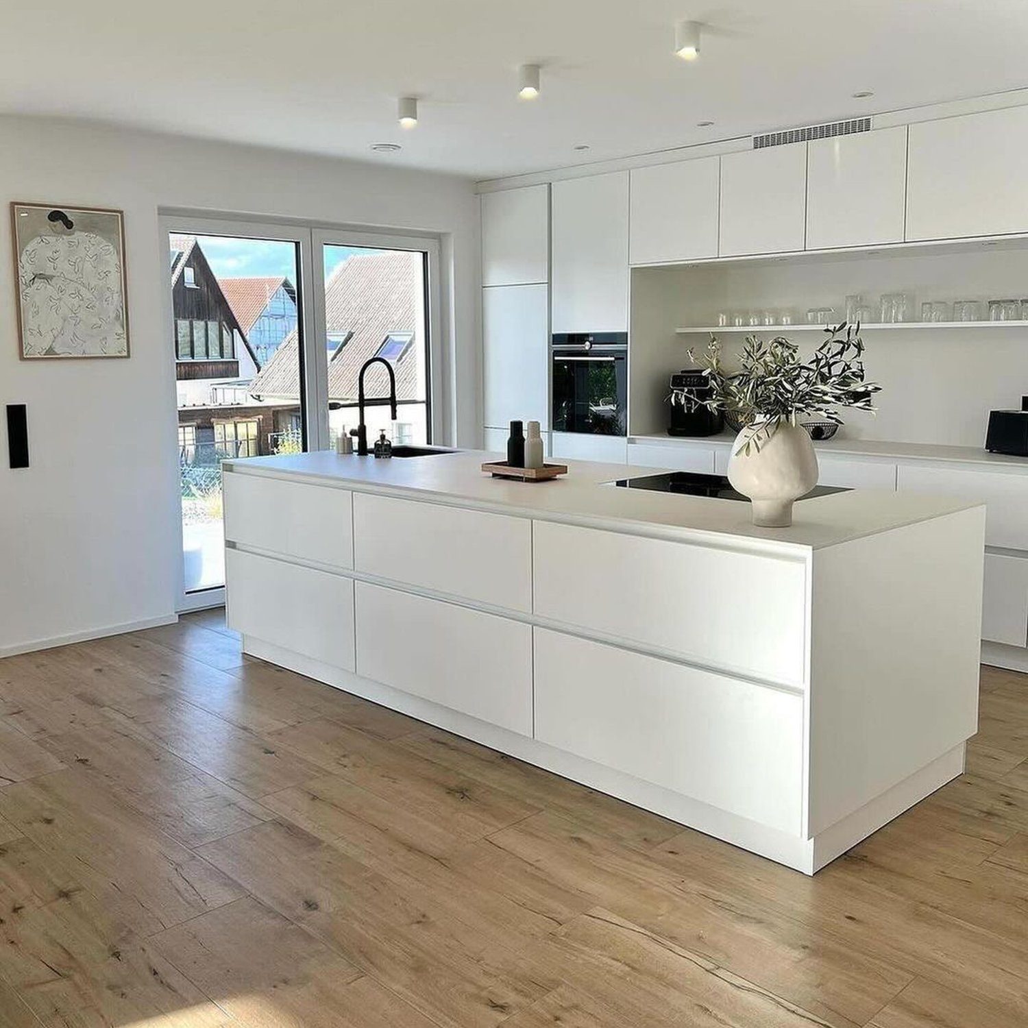 A sleek and modern kitchen with abundant natural light