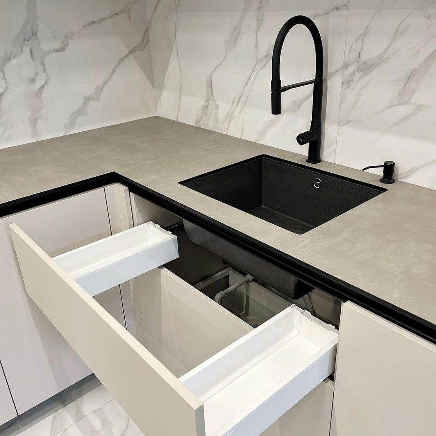 Elegant kitchen design featuring an undermount sink with black fixtures