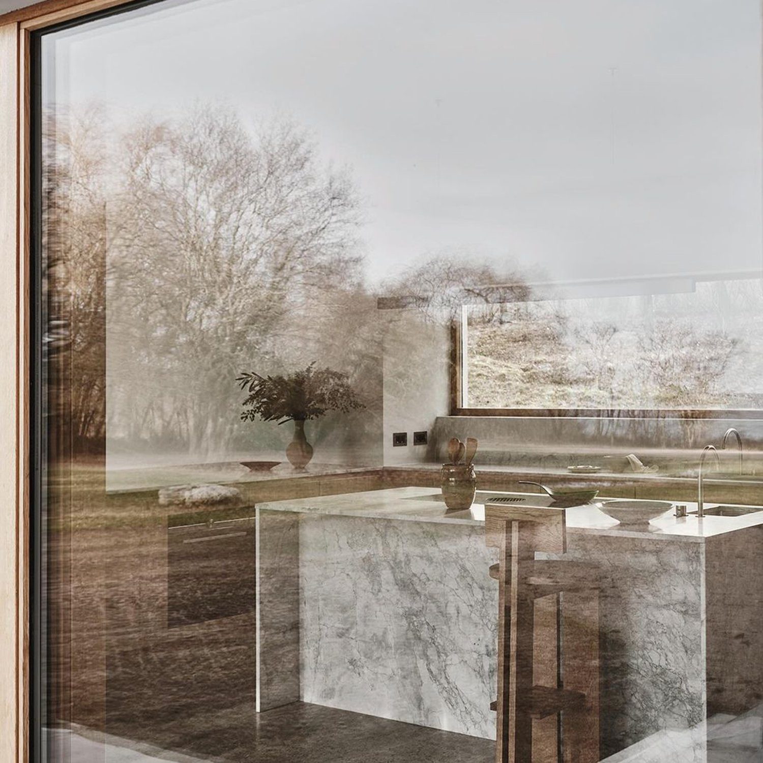 Reflective view of a modern kitchen through a window