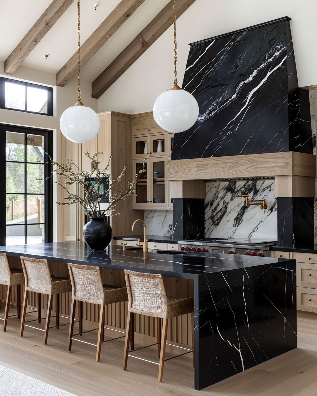 A modern kitchen space featuring rich black marble counters with striking white veining, complemented by wooden cabinetry and natural light.