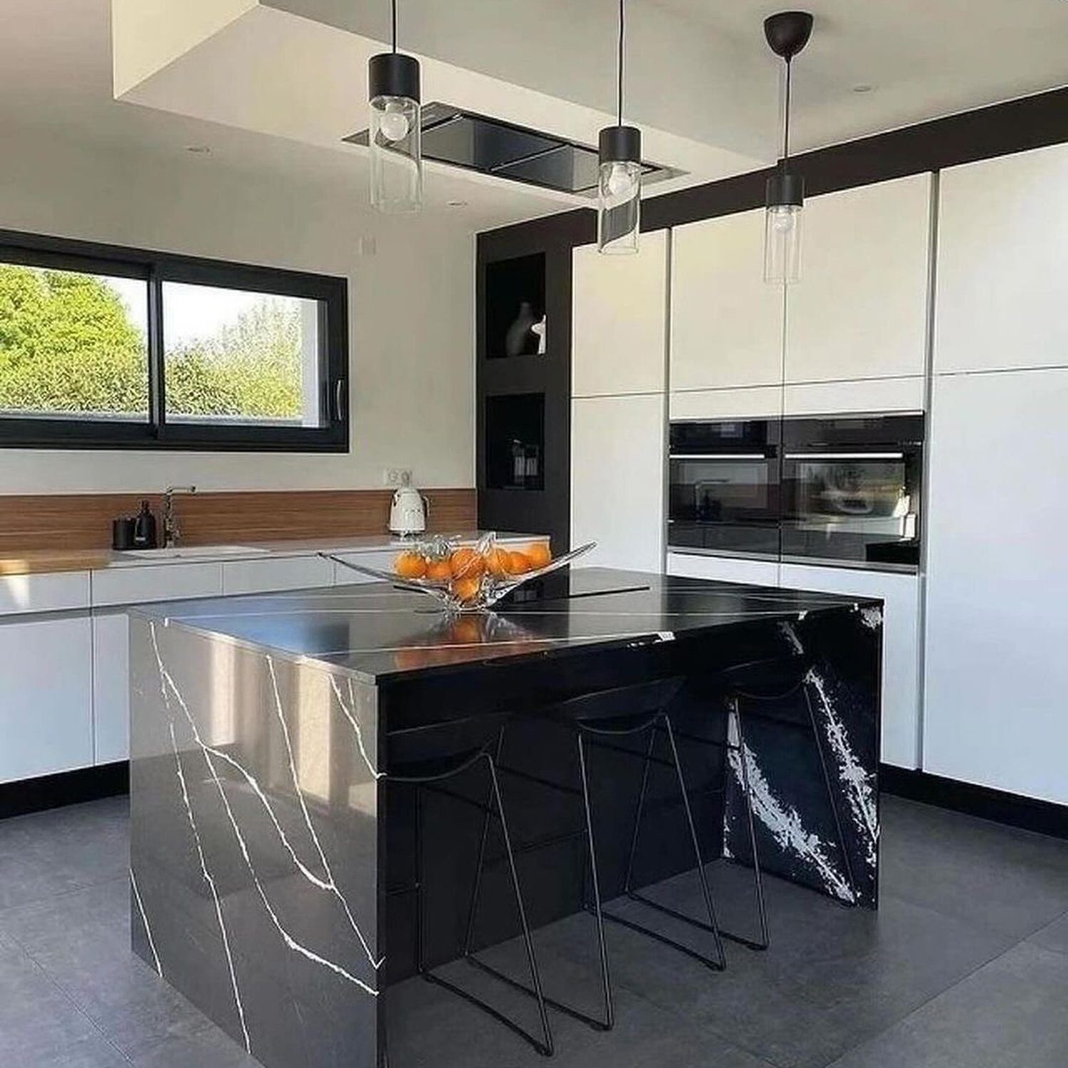 A modern kitchen with sleek black marble island