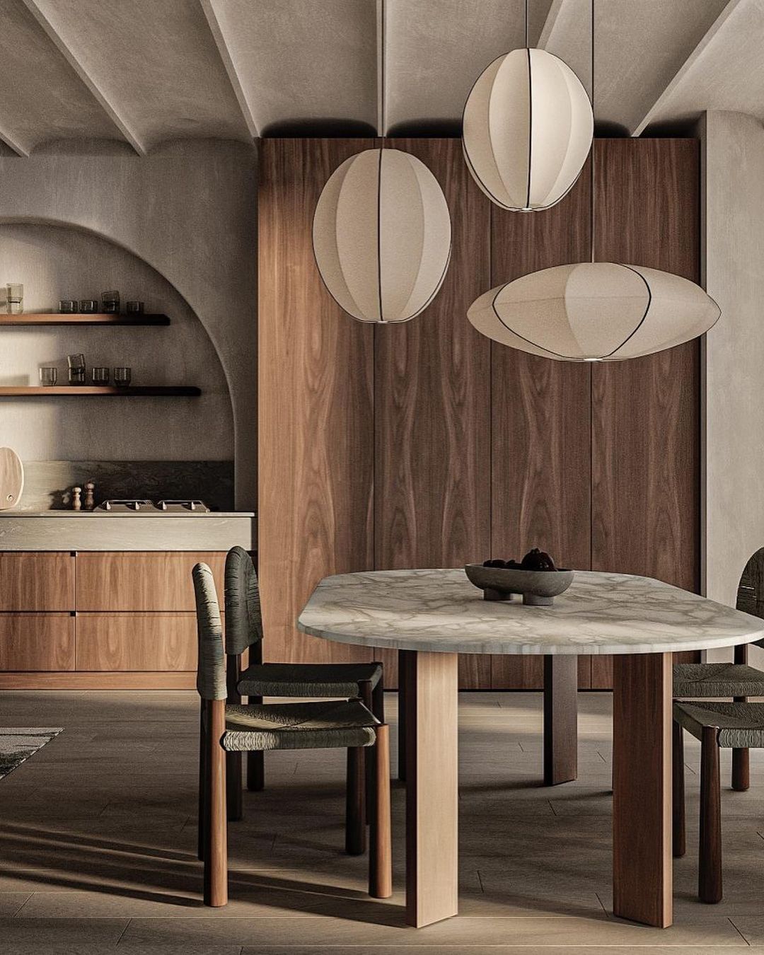 A modern kitchen and dining space featuring wooden cabinetry and a marble table