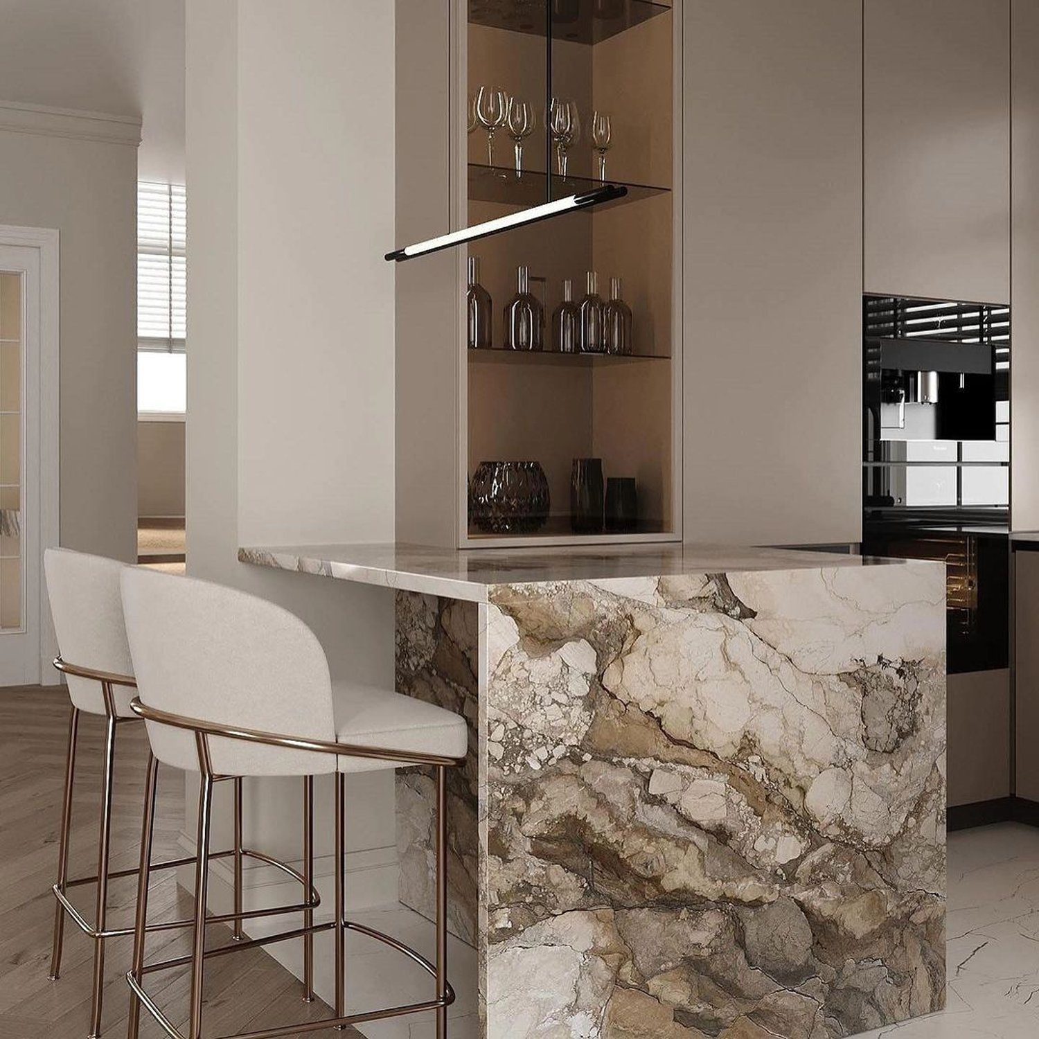 An elegantly designed modern kitchen featuring a marble bar island