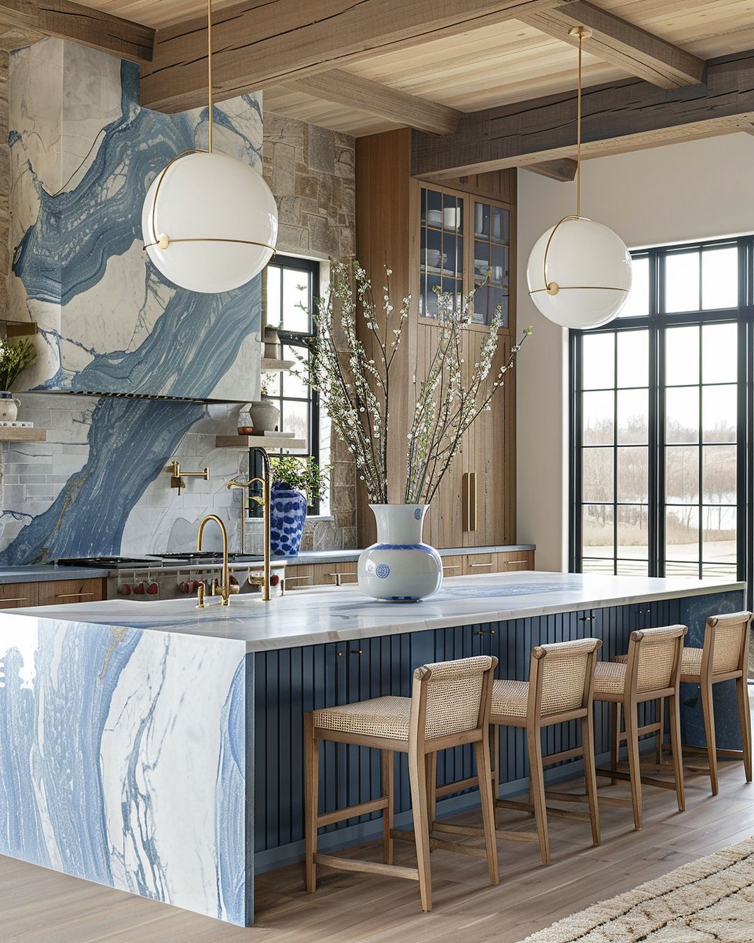 A chic modern kitchen featuring a bold blue and white marble island