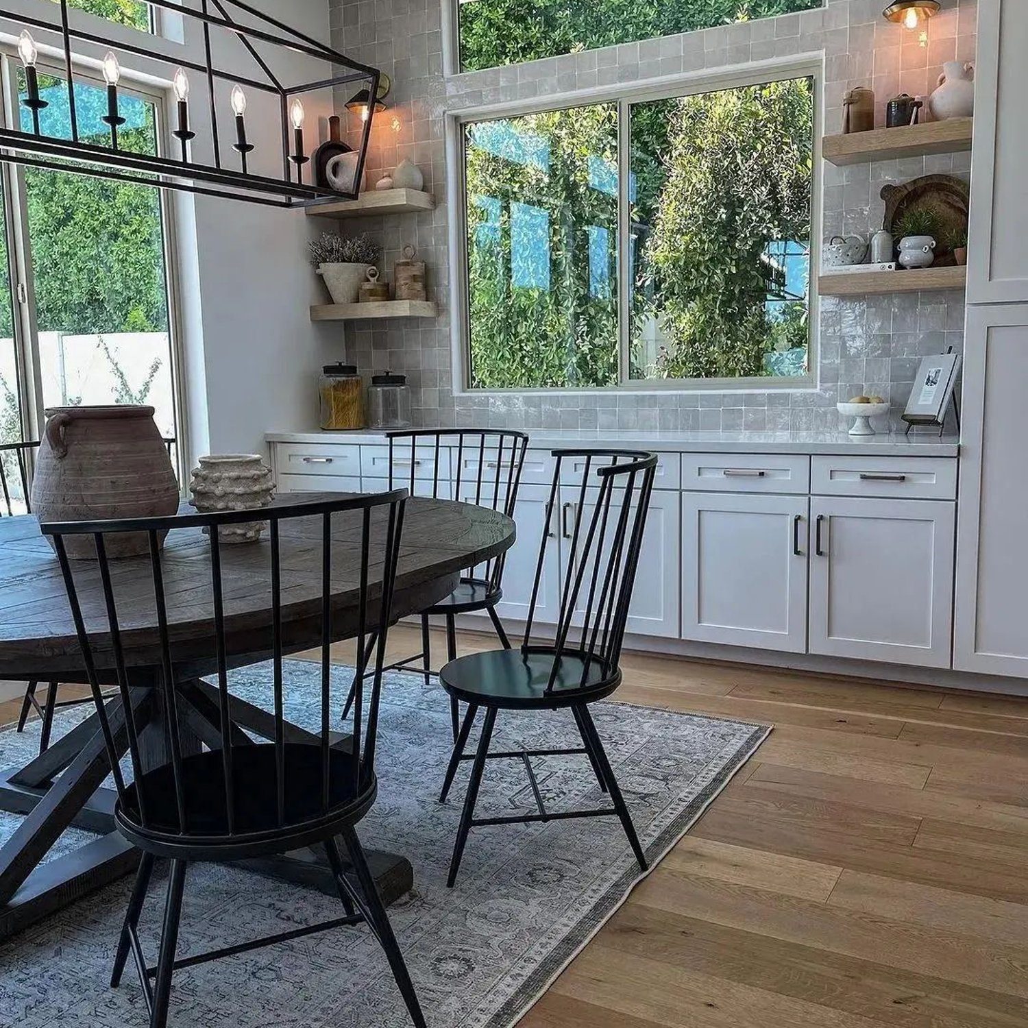 A modern kitchen with large windows and natural light