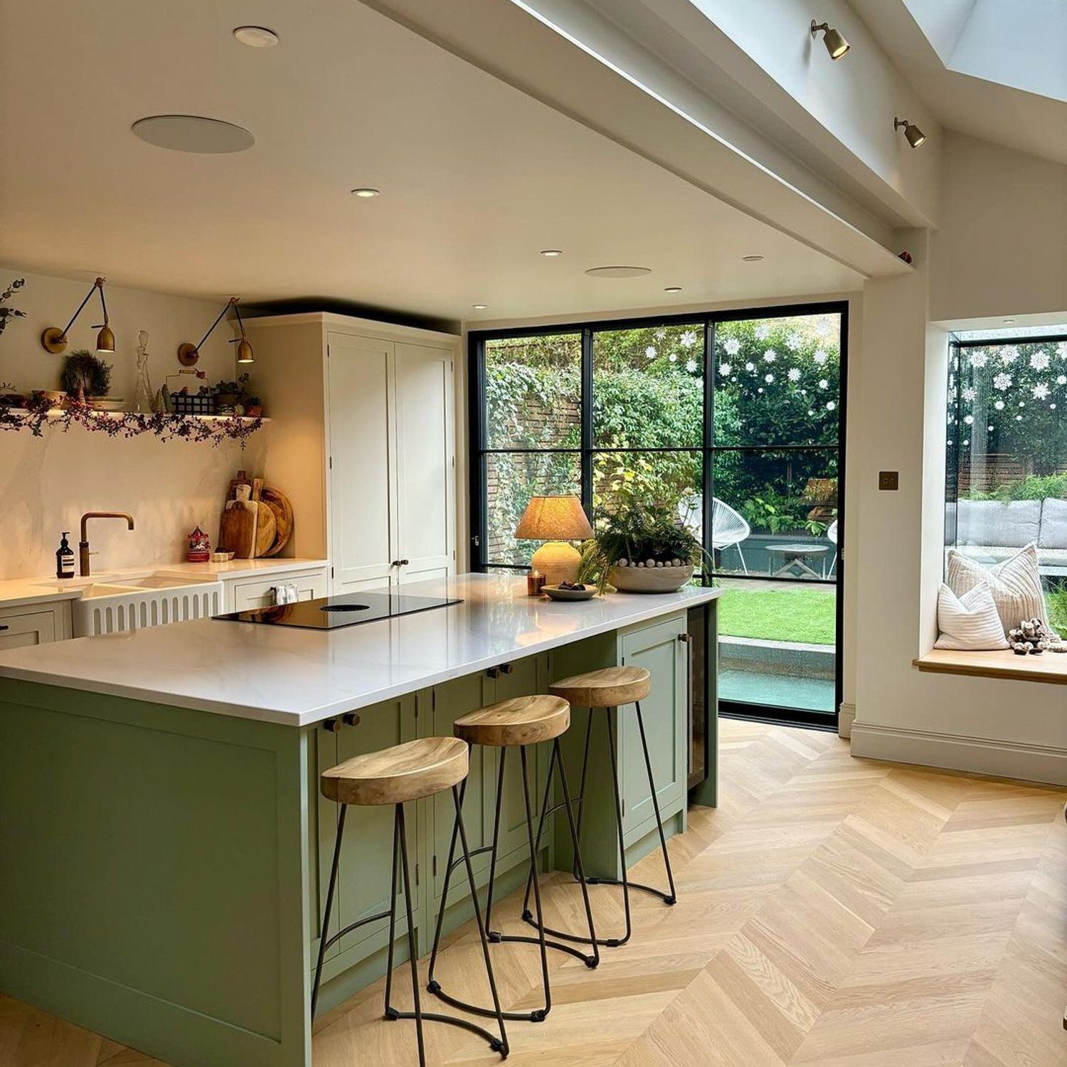 A bright and spacious kitchen with herringbone floor and sleek modern design