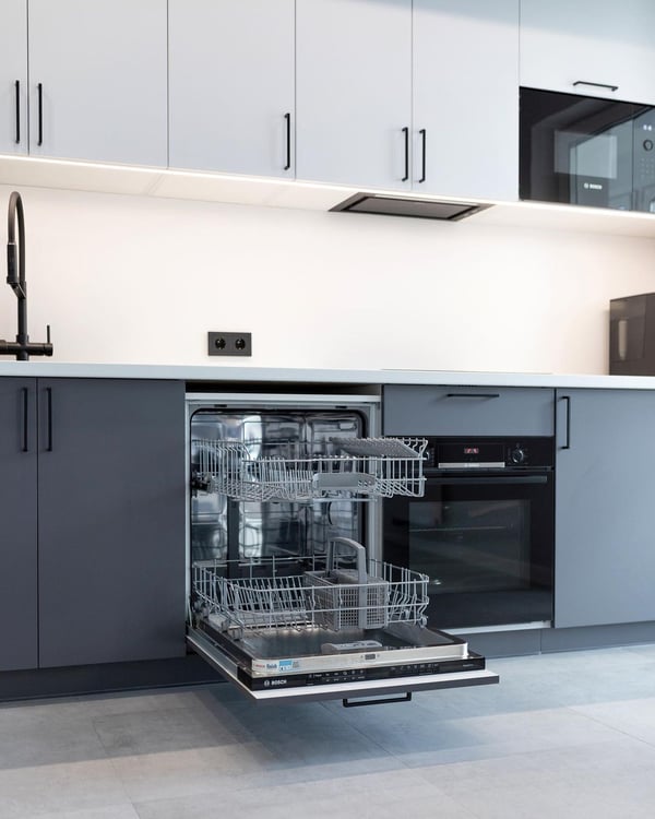 A sleek and modern kitchen featuring a fully open dishwasher