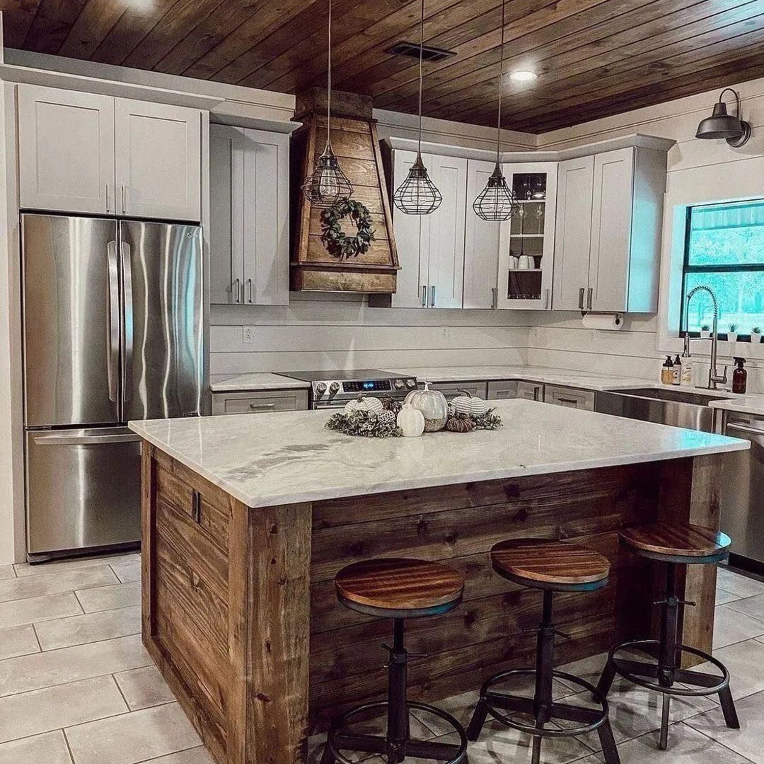 A modern kitchen with a blend of rustic charm featuring stainless steel appliances