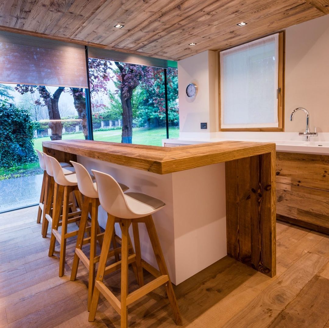 A modern kitchen with a blend of rustic textures and sleek design