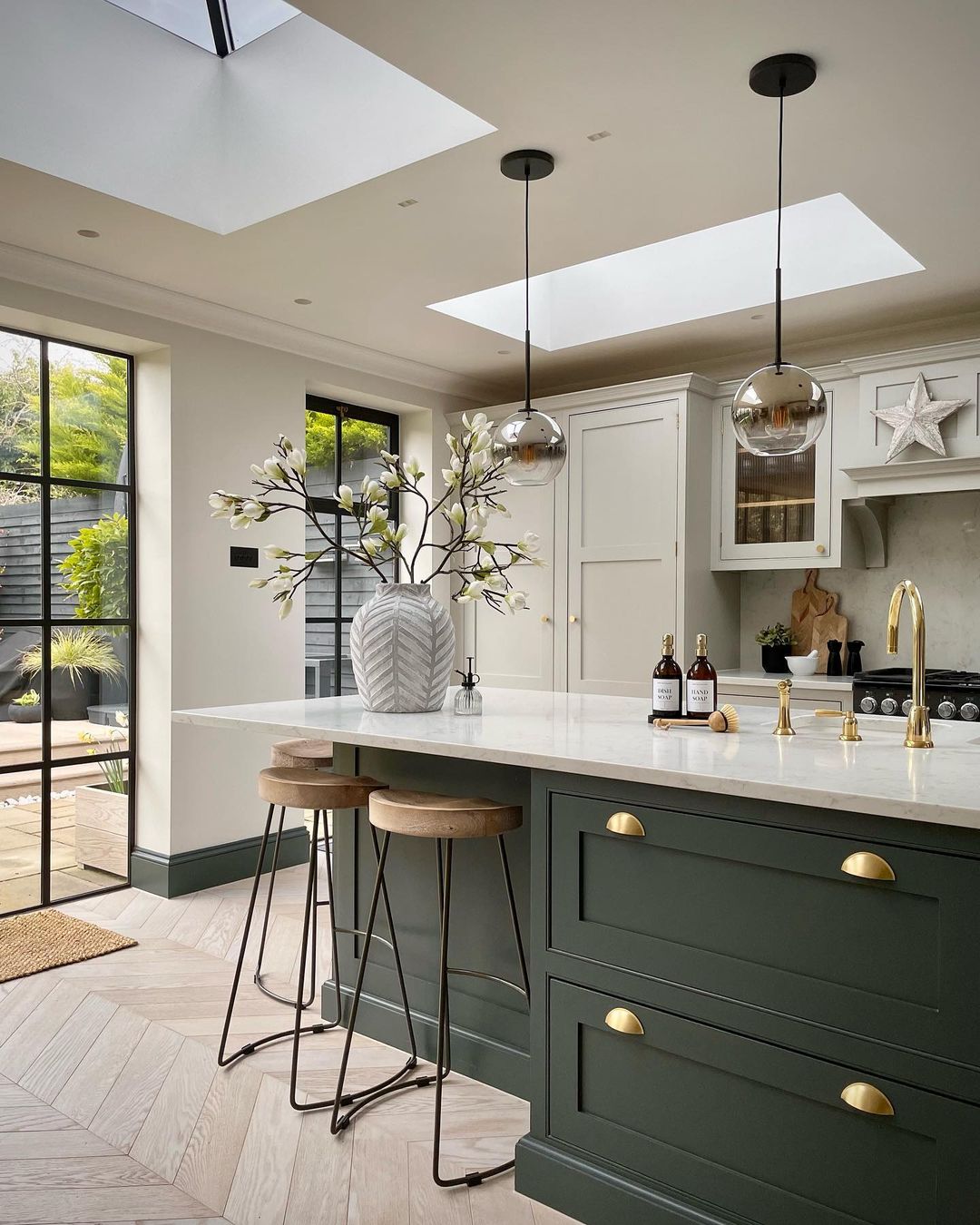 A modern kitchen space with natural light pouring through skylights