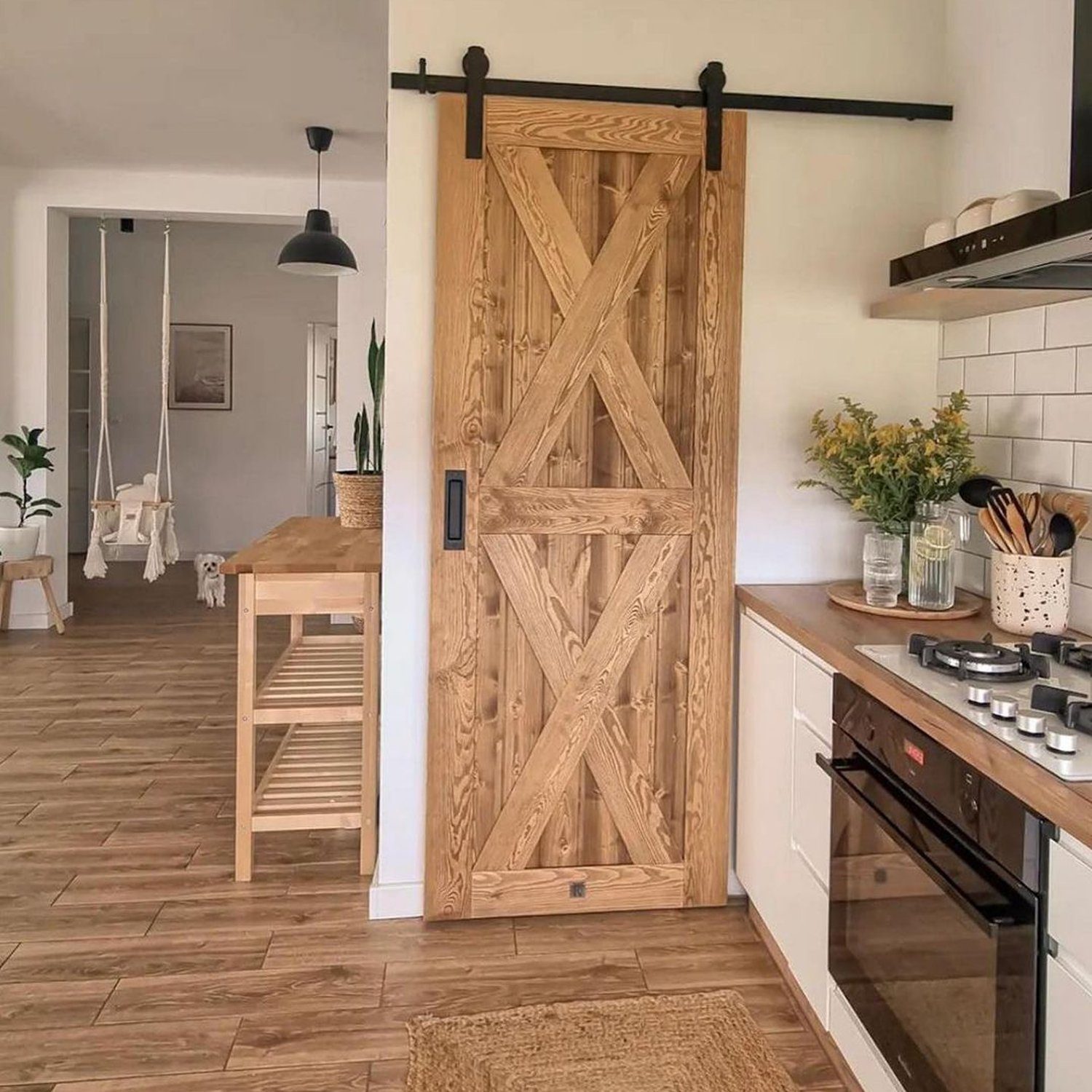 A stylish and functional kitchen space featuring a sliding barn door