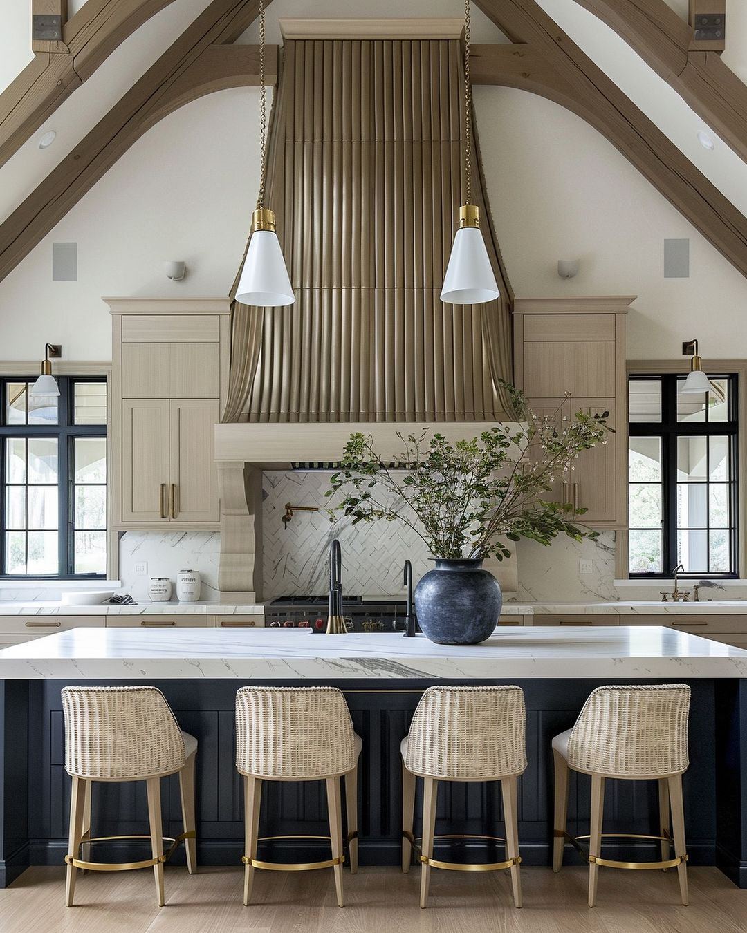 A chic, modern kitchen with a soaring vaulted ceiling