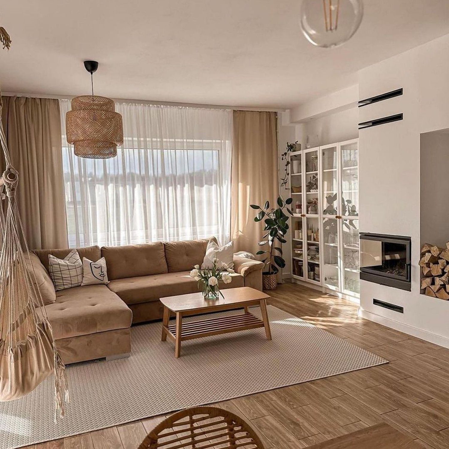 A cozy and modern living room with natural light filtering through sheer curtains