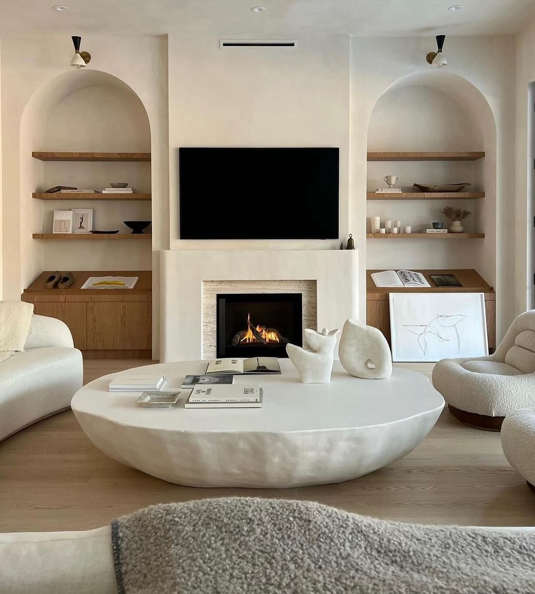 Inviting and stylish living room design featuring a sleek modern fireplace and built-in shelving