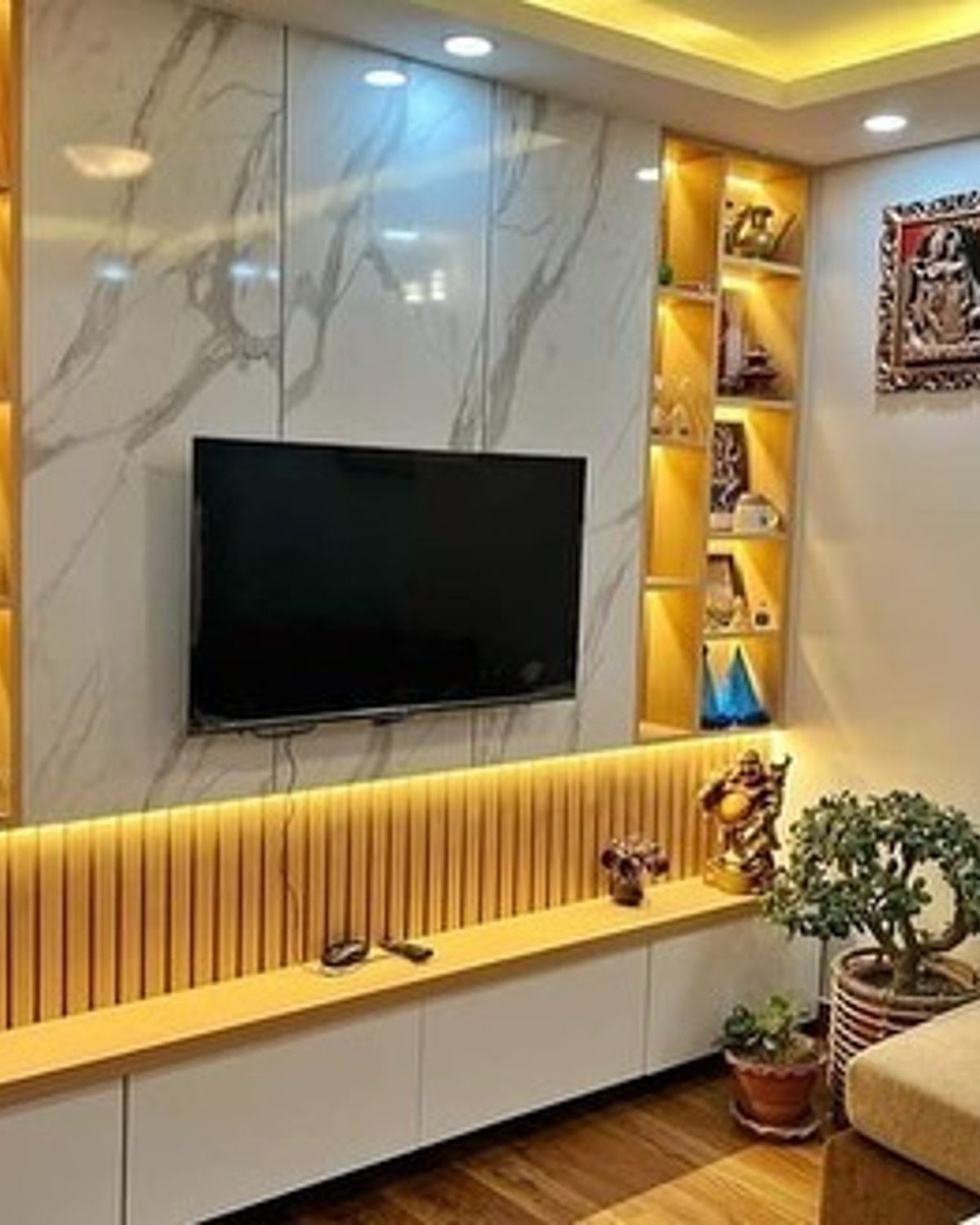 Elegantly designed living room with illuminated shelves and a minimalist TV unit