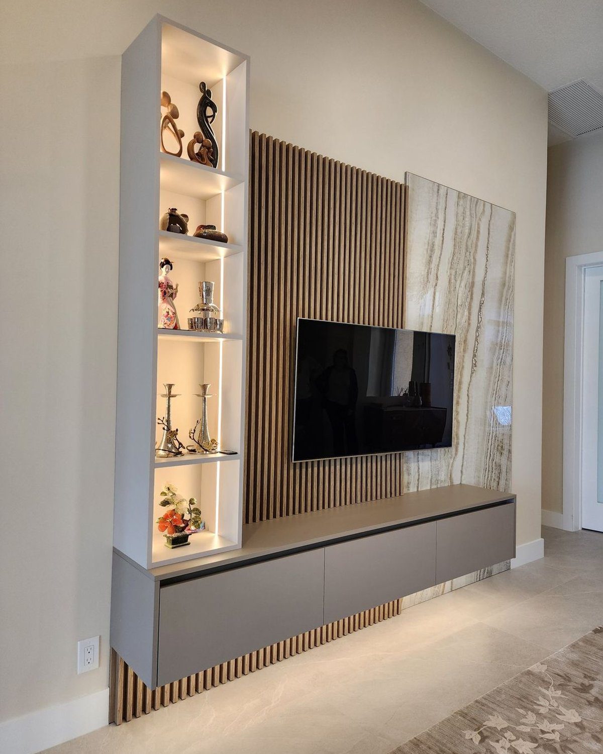 Elegant living room wall unit featuring a built-in shelf and television arrangement