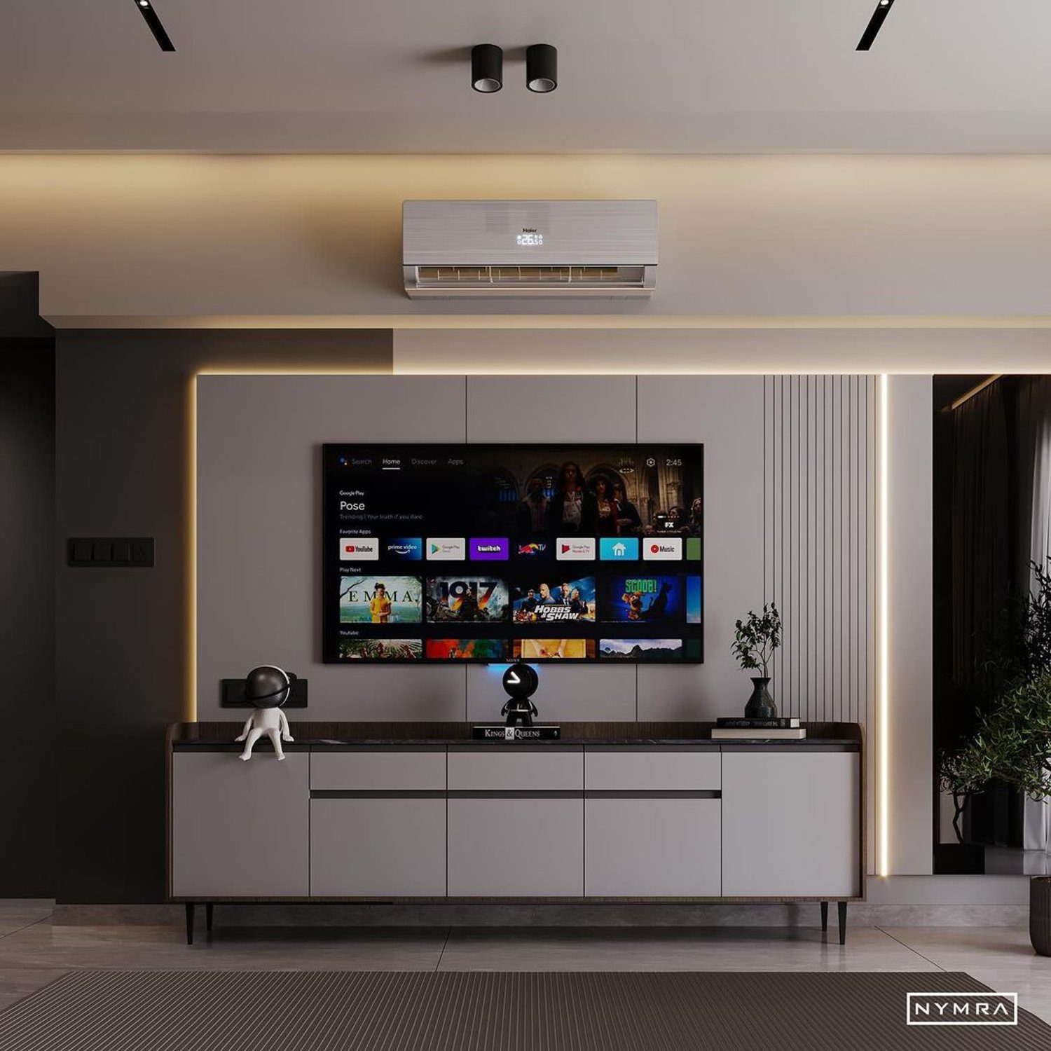 A sleek modern living room featuring a mounted flat-screen TV, gray cabinetry, and ambient lighting