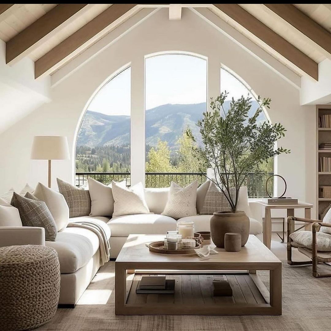 Cozy mountain-view living room with large arched windows