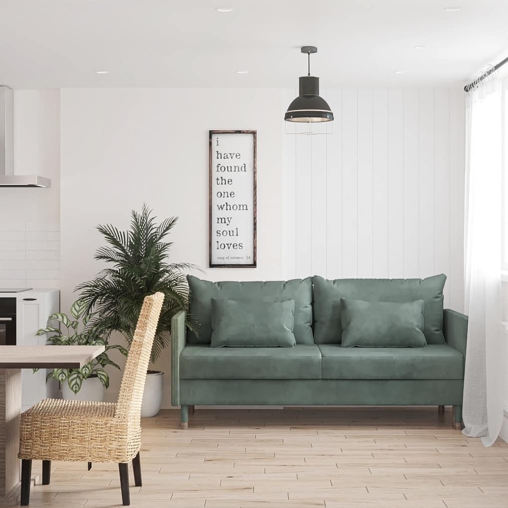 A cozy and modern living room with a wicker chair and a plush green sofa