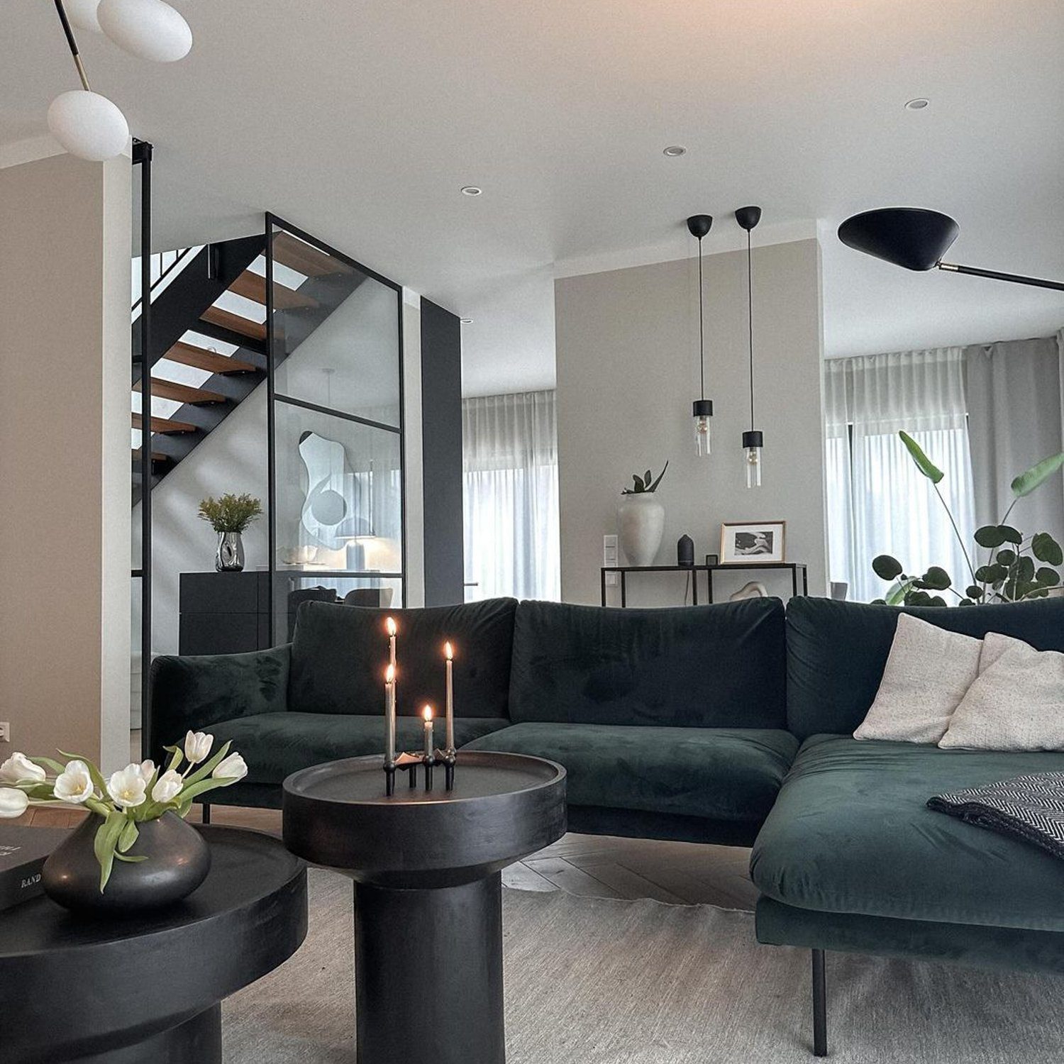 Elegant and modern living room with a dark green velvet sofa