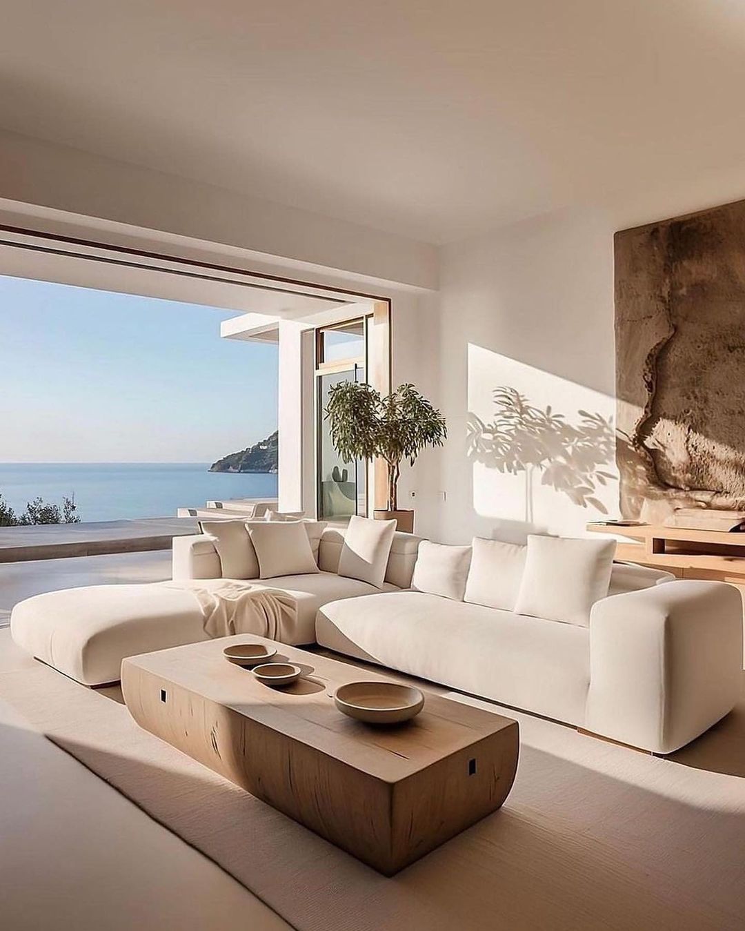 A modern living room with a panoramic view of the sea