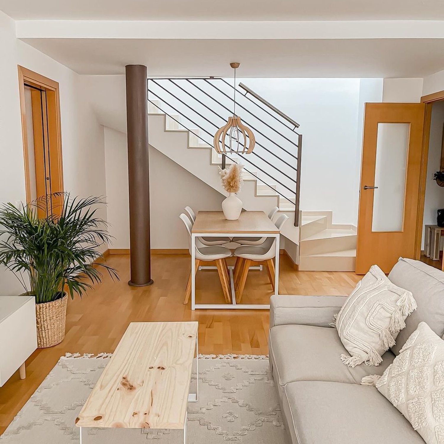 A modern and airy living room with a staircase