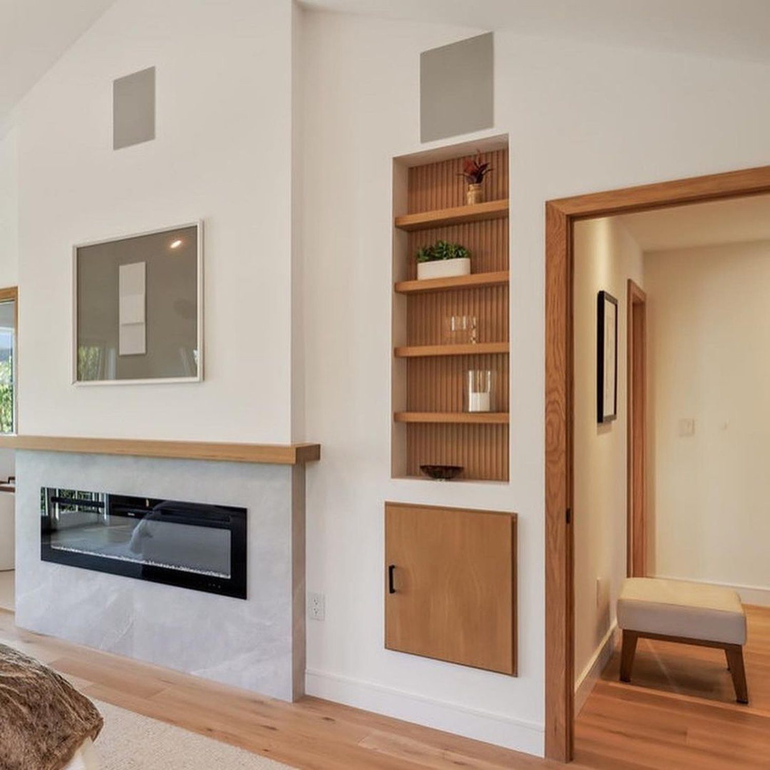 Modern living space with integrated shelving and fireplace