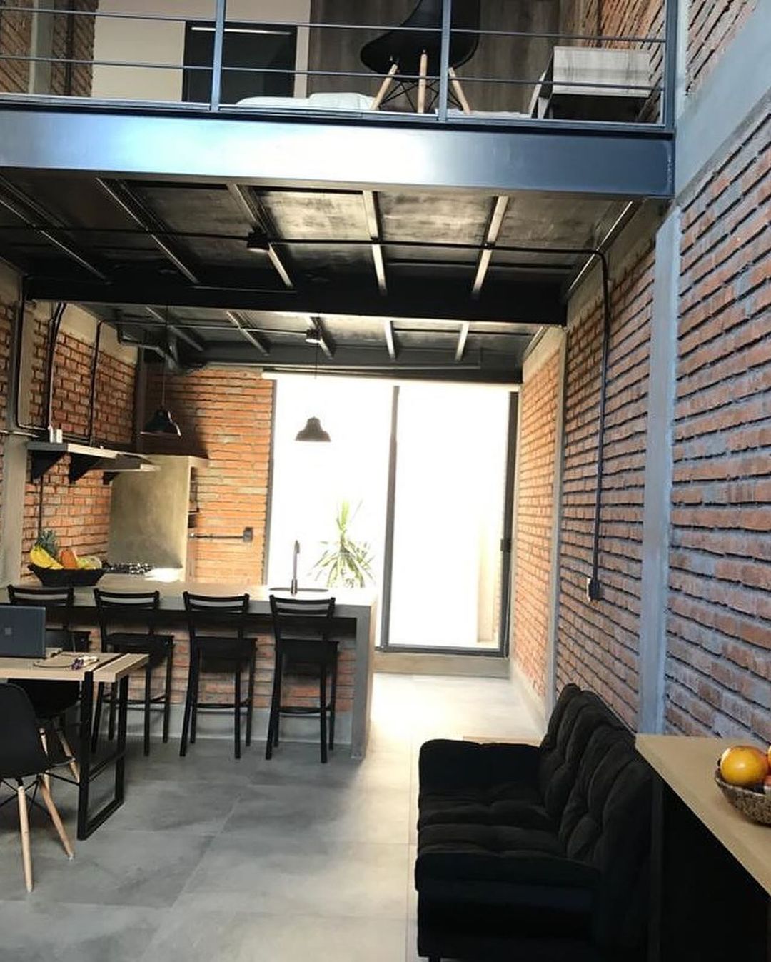 Loft-style interior with exposed brick walls and black accents