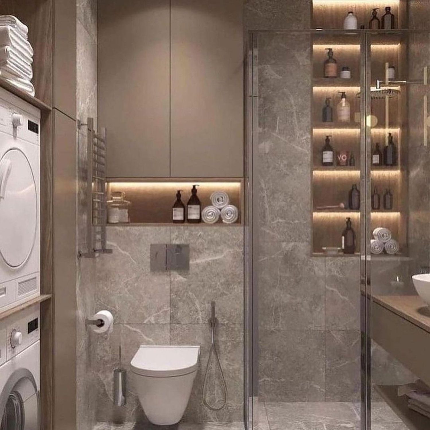 A sleek and modern bathroom design featuring marble tiling, a frameless glass shower, and neatly integrated laundry appliances.