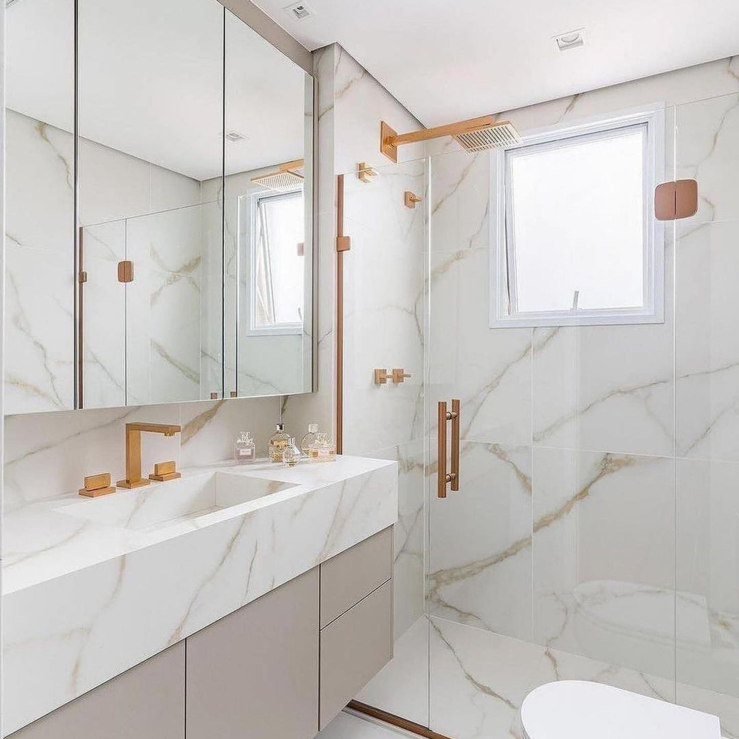 Elegant marble bathroom with copper accents