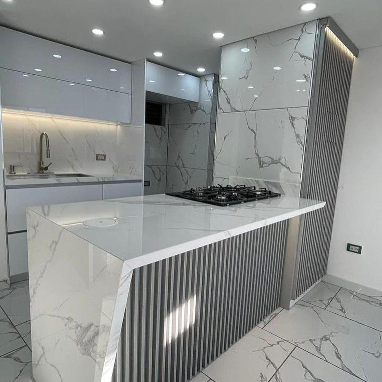 A sleek and modern kitchen design with striking marble patterns and minimalistic cabinetry