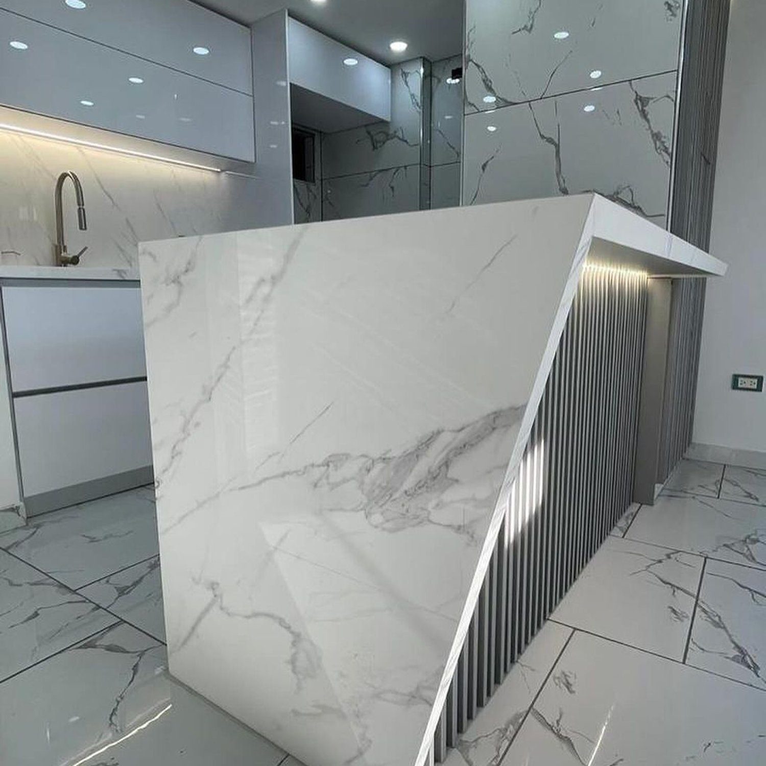 An elegant marble-themed kitchen with a distinctive modern design