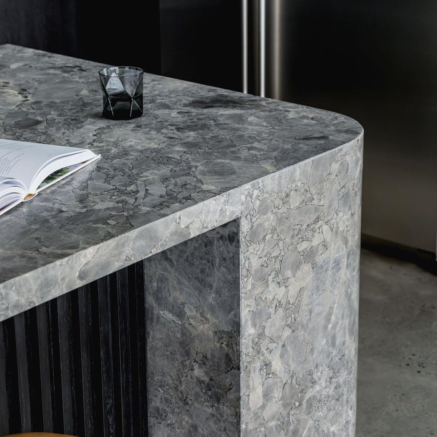 Elegant kitchen island featuring striated dark texture