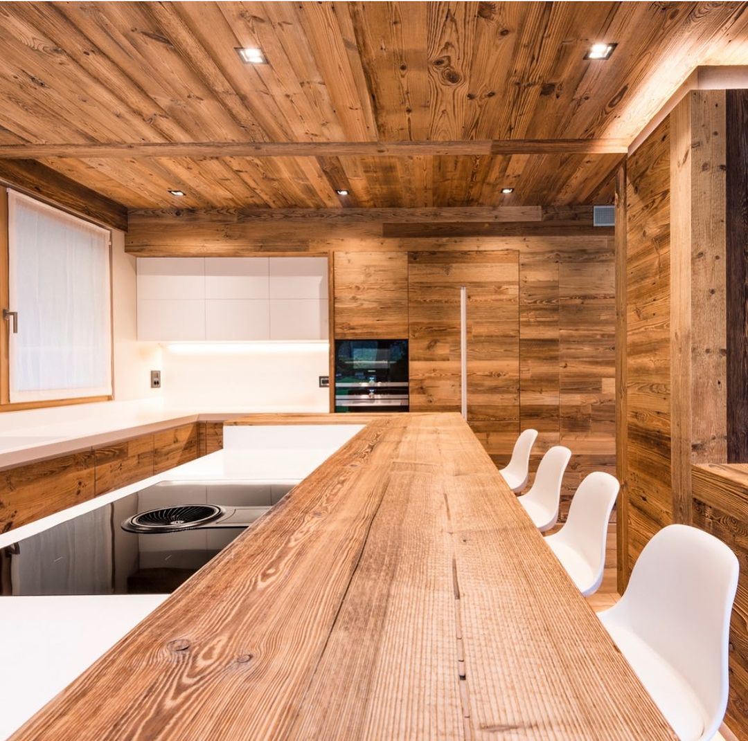 A seamlessly integrated modern kitchen with rustic wooden accents