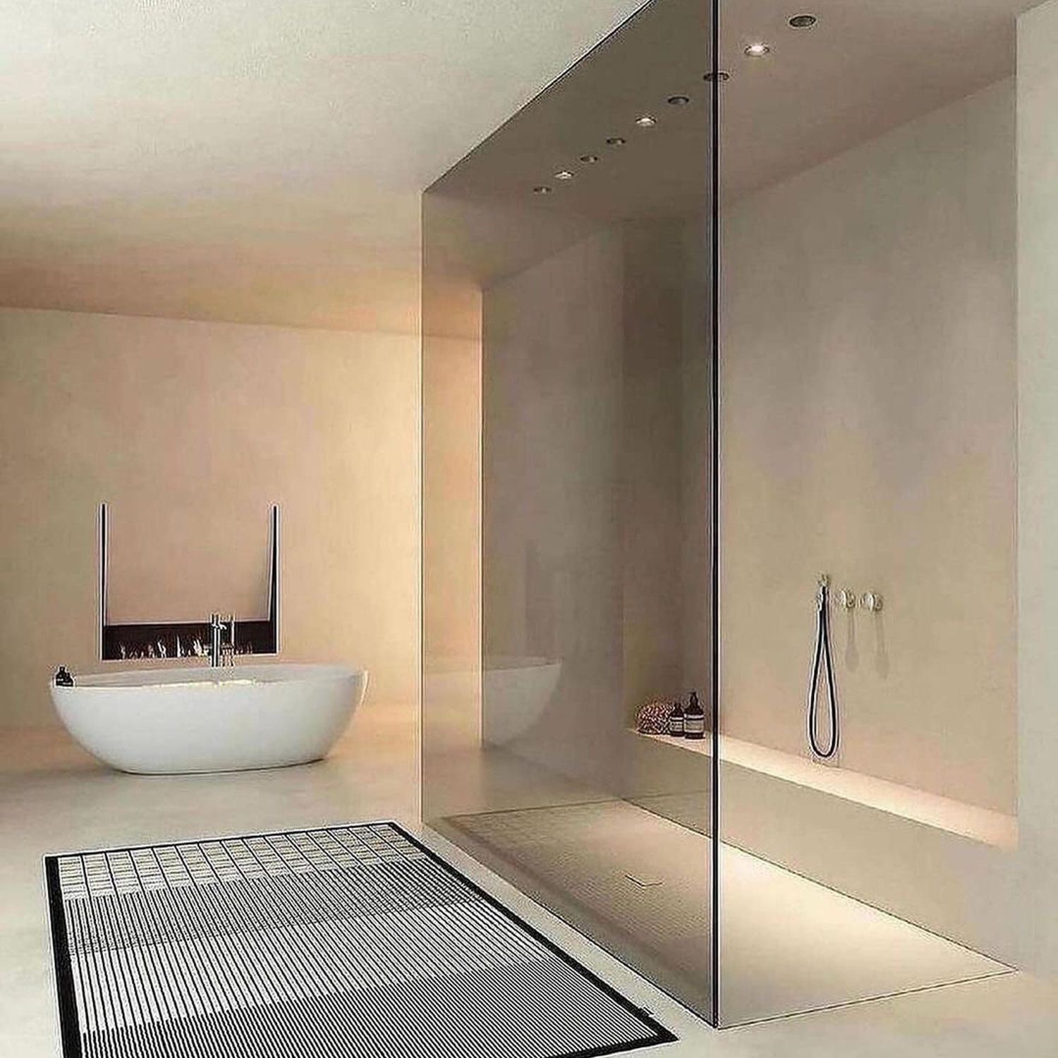 A minimalist bathroom featuring an elegant freestanding bathtub and a sleek walk-in shower with a glass partition