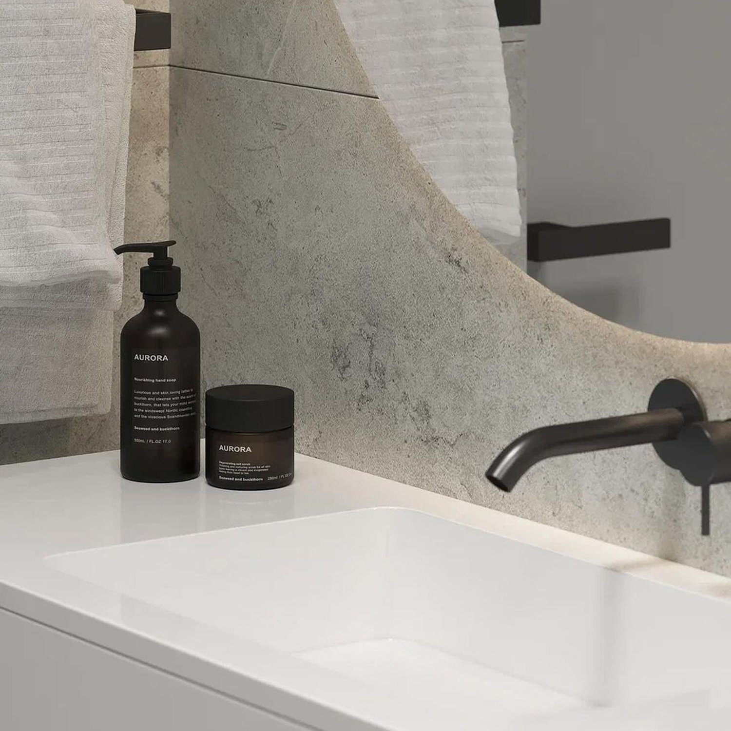 A modern minimalist bathroom featuring a sleek rectangular sink, matte black fixtures, and textured grey wall tiles