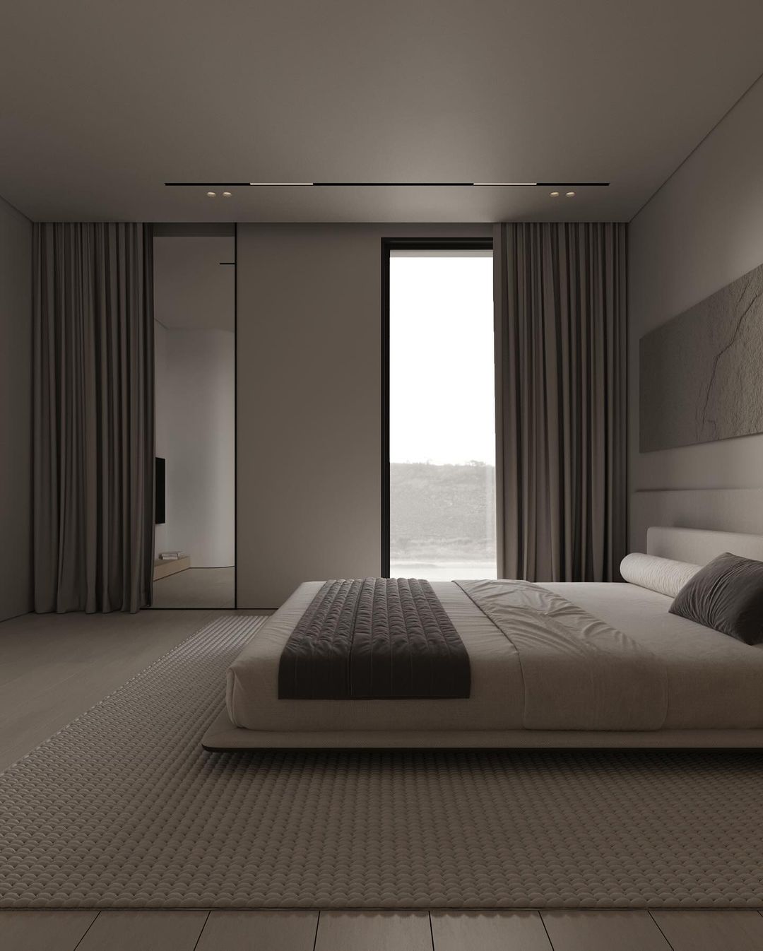 A modern minimalist bedroom featuring a low-profile platform bed