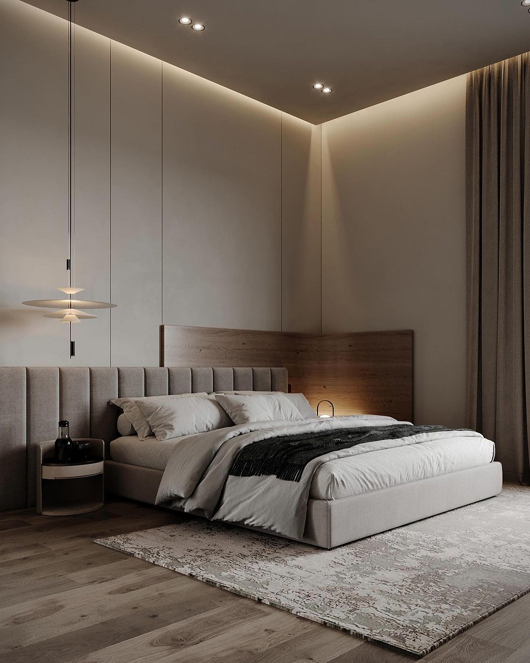 A modern and minimalist bedroom featuring a plush upholstered bed