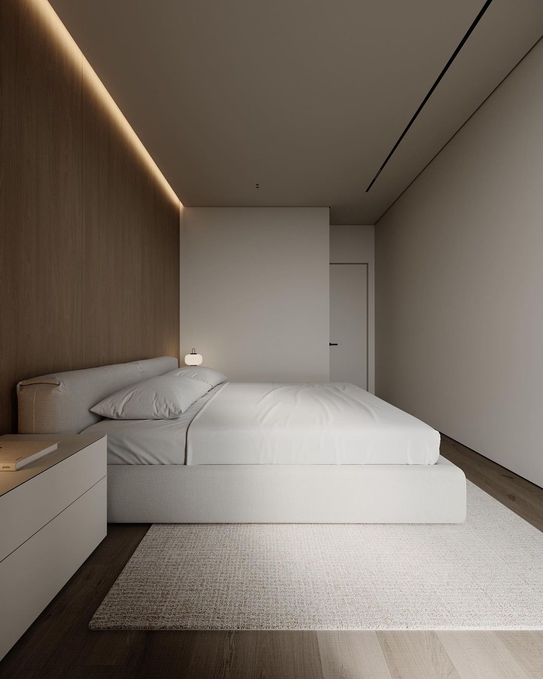 A minimalist bedroom featuring warm wooden tones and soft textures