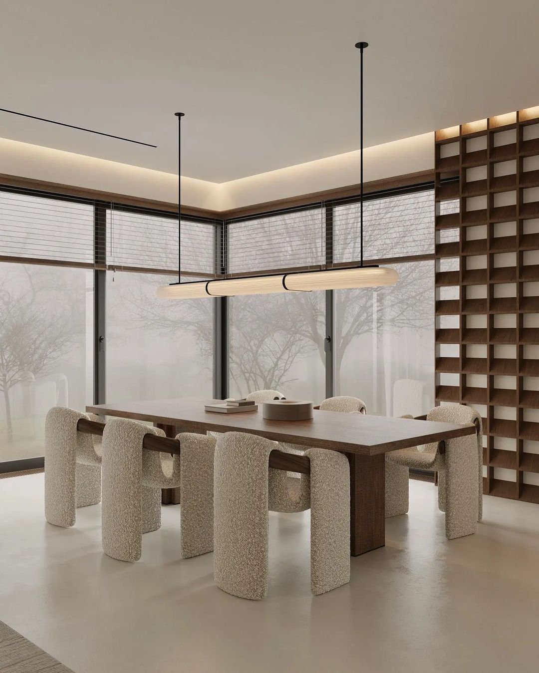 A modern and minimalist dining room with unique textured chairs and a sleek wooden table