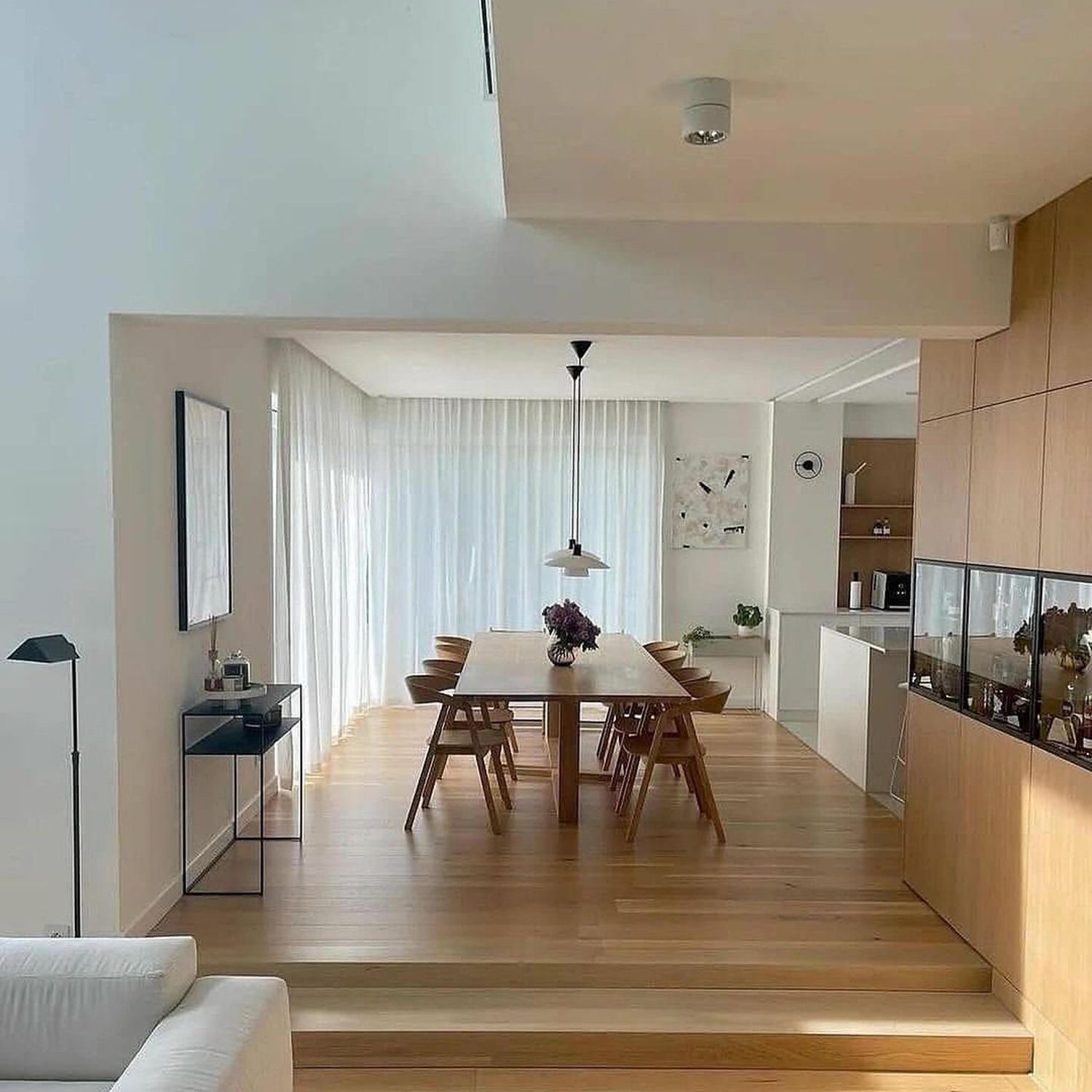 A minimalist dining and kitchen area with seamless design