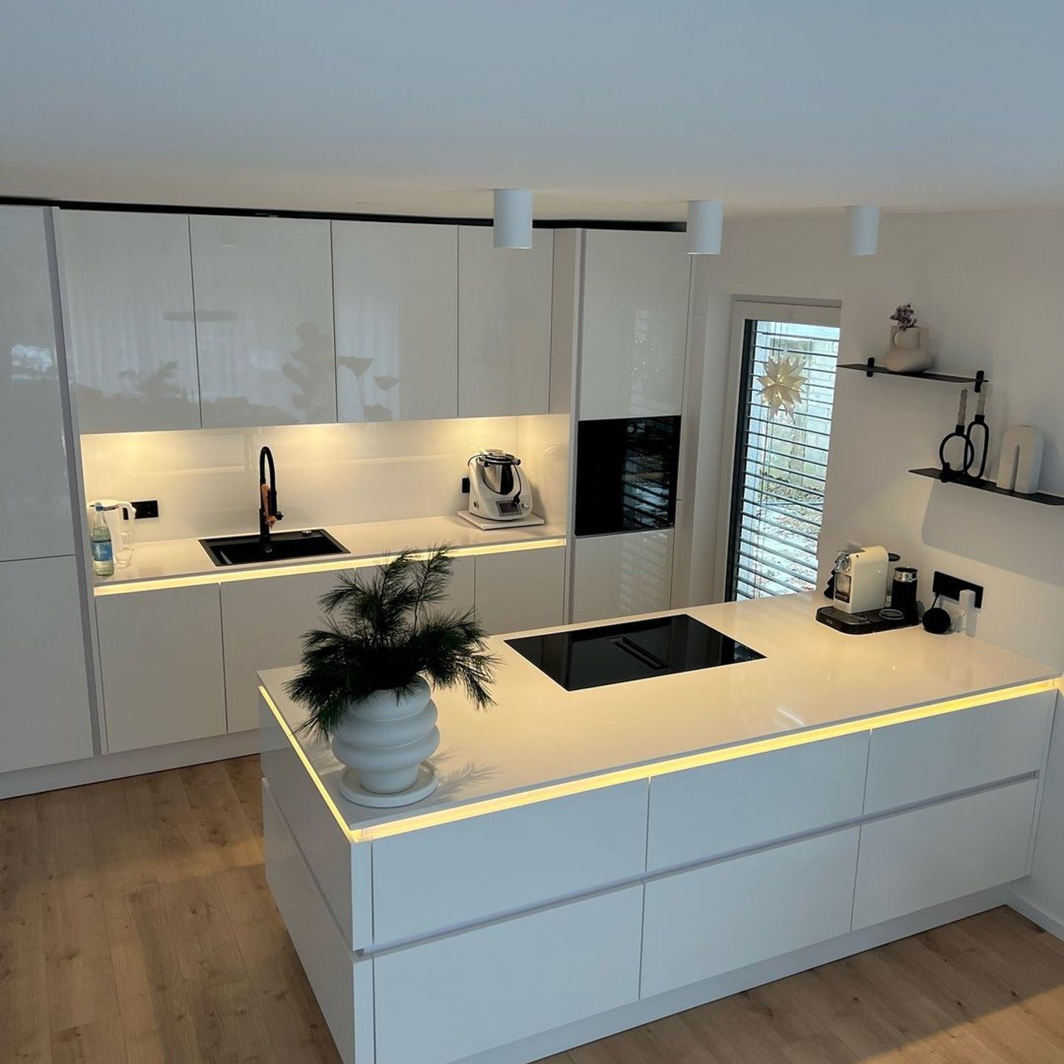 A modern minimalist kitchen with clean lines and a neutral color palette