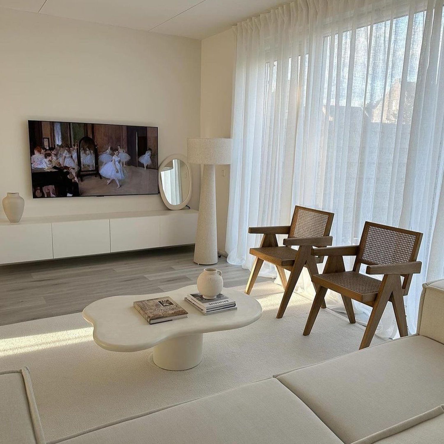 A modern minimalist living room with an abundance of natural light