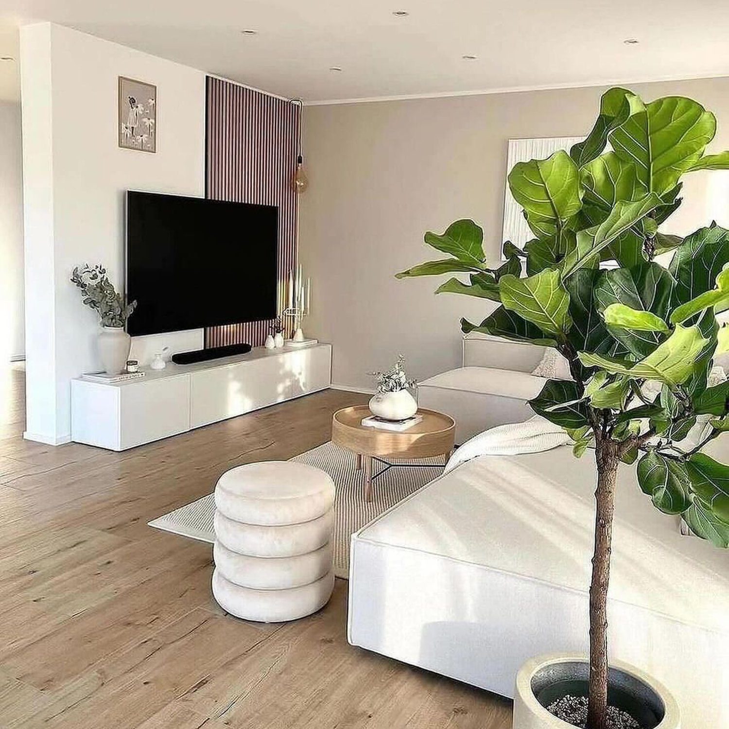 A minimalist living room design featuring neutral tones and natural elements.